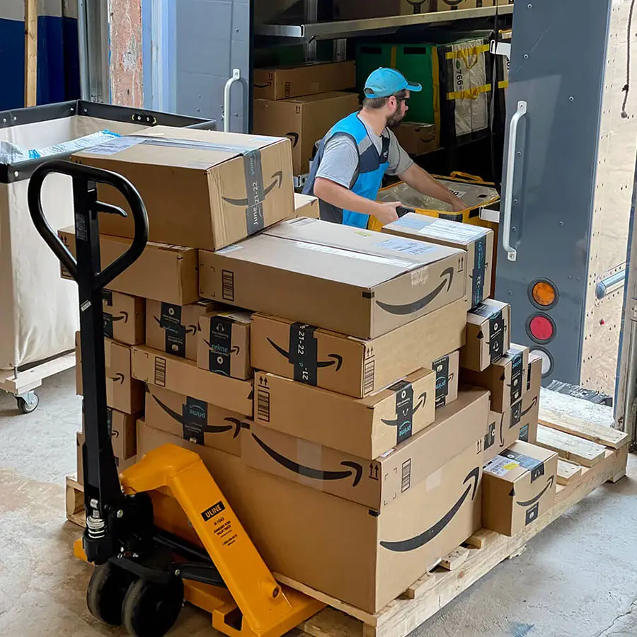Prep center worker receiving boxes on a pallet